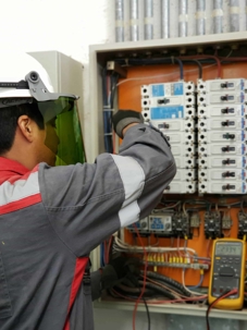 Emergency electrician examining a malfunctioning breaker panel